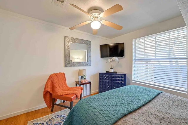 1265 Du Barry Ln, Houston, TX 77018 - bedroom featuring wood finished floors, baseboards, a ceiling fan, and visible vents