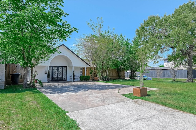 1265 Du Barry Ln, Houston, TX 77018 - view of front of property featuring a front yard, fence, concrete driveway, french doors, and stucco siding
