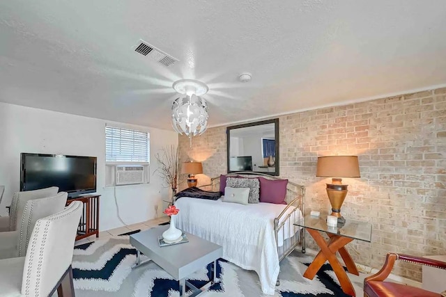 1265 Du Barry Ln, Houston, TX 77018 - bedroom with visible vents, cooling unit, brick wall, and a textured ceiling