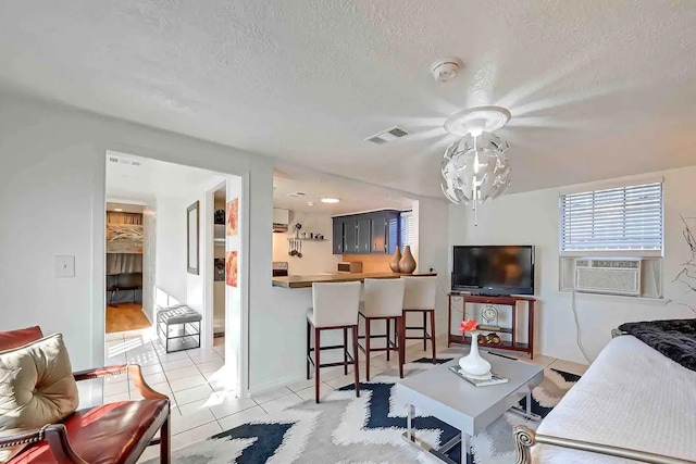 1265 Du Barry Ln, Houston, TX 77018 - living room with cooling unit, visible vents, a textured ceiling, and light tile patterned flooring
