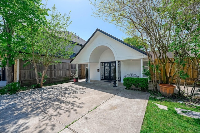 1265 Du Barry Ln, Houston, TX 77018 - view of front of home featuring stucco siding, fence, and french doors