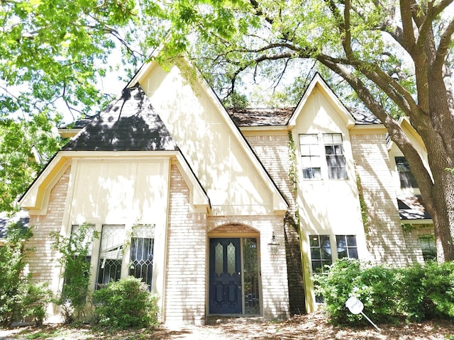 entrance to property featuring brick siding