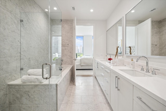 full bath with connected bathroom, a sink, double vanity, and recessed lighting