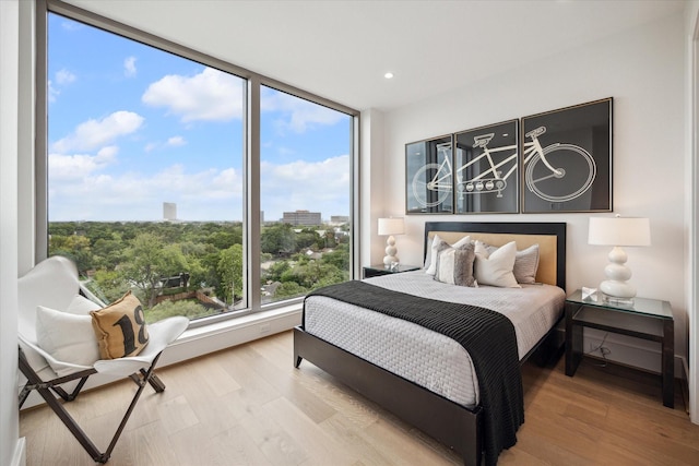 bedroom featuring wood finished floors and recessed lighting