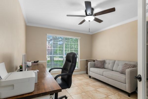 office area featuring light tile patterned flooring, baseboards, crown molding, and ceiling fan