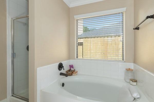 full bath with a bath, ornamental molding, and a stall shower