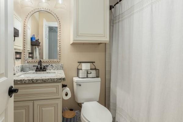 full bathroom with vanity and toilet