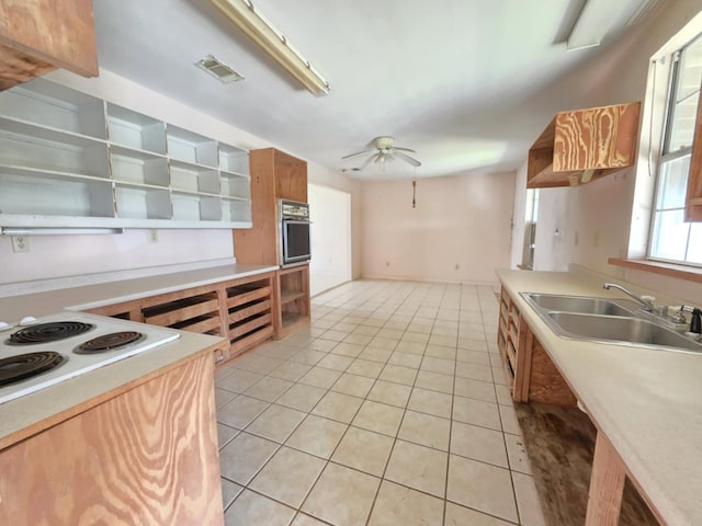 900 Mariner St, Sargent, TX 77414 - kitchen featuring open shelves, light tile patterned flooring, stainless steel oven, a sink, and ceiling fan