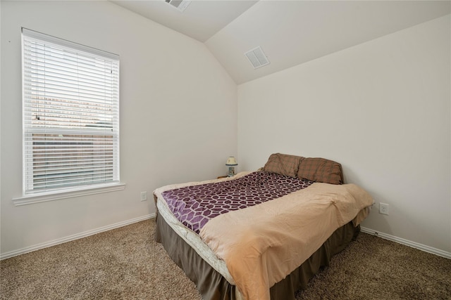 carpeted bedroom with visible vents, baseboards, and lofted ceiling