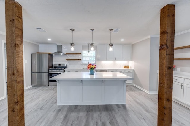 kitchen with wall chimney exhaust hood, appliances with stainless steel finishes, baseboards, and ornamental molding