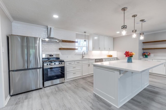 kitchen featuring open shelves, wall chimney range hood, ornamental molding, and stainless steel appliances