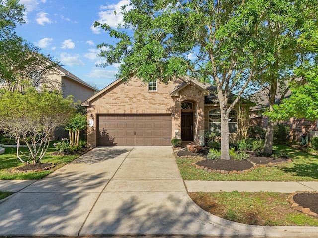 605 Pedernales St, Webster, TX 77598 - view of front of house featuring brick siding, concrete driveway, and an attached garage
