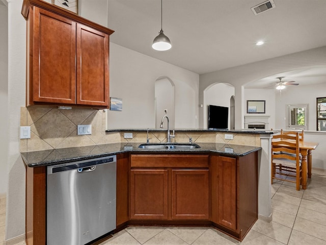 605 Pedernales St, Webster, TX 77598 - kitchen with dishwasher, a sink, a peninsula, arched walkways, and light tile patterned flooring