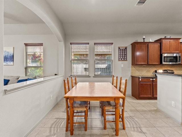 605 Pedernales St, Webster, TX 77598 - dining space featuring arched walkways and light tile patterned floors