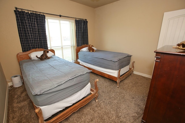 carpeted bedroom featuring baseboards