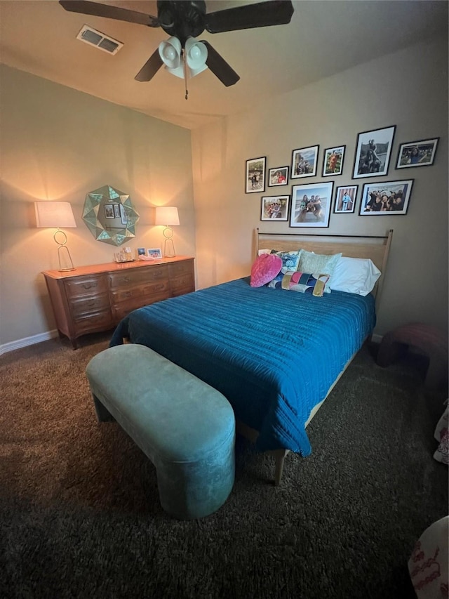 carpeted bedroom featuring visible vents, baseboards, and ceiling fan
