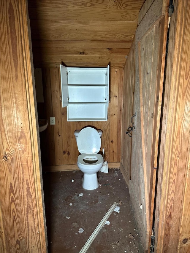 bathroom with wooden walls, toilet, and wooden ceiling