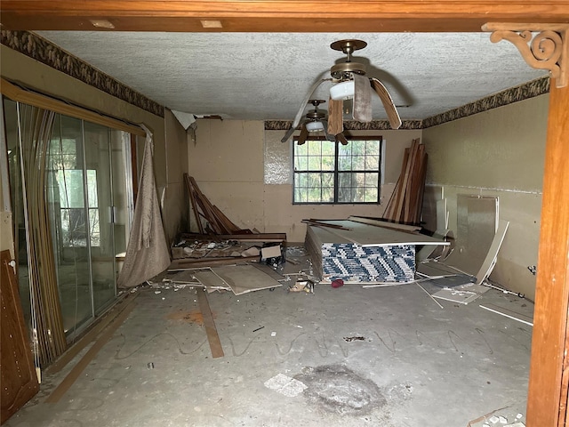 spare room featuring a textured ceiling and ceiling fan