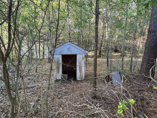 view of shed featuring a wooded view