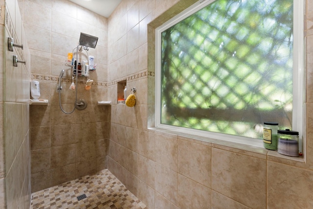 full bath with a tile shower