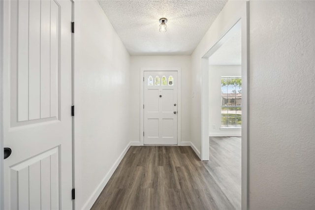 12418 A Bar Dr, Santa Fe, TX 77510 - foyer with dark wood finished floors, a textured ceiling, and baseboards
