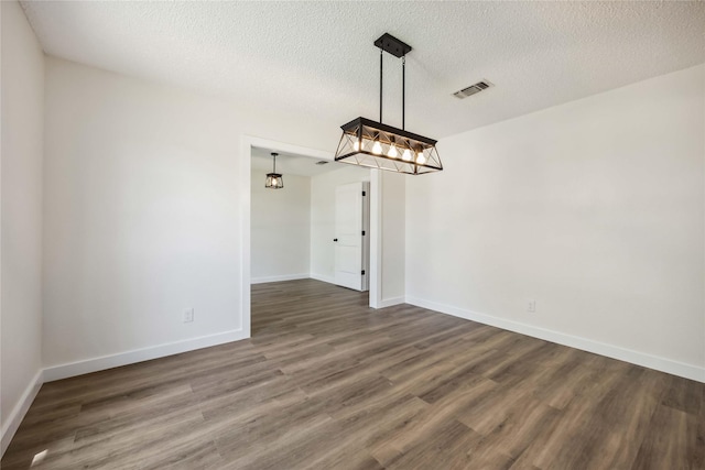 12418 A Bar Dr, Santa Fe, TX 77510 - unfurnished dining area with wood finished floors, baseboards, and a textured ceiling