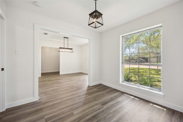 12418 A Bar Dr, Santa Fe, TX 77510 - unfurnished dining area with dark wood finished floors, baseboards, and a chandelier