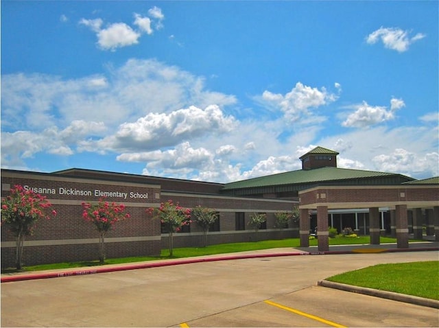 view of property featuring uncovered parking