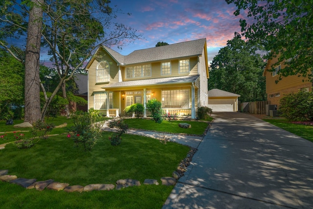 traditional home featuring a porch, a garage, an outbuilding, and roof with shingles