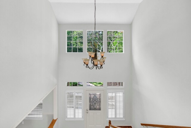 entryway featuring a chandelier and a towering ceiling