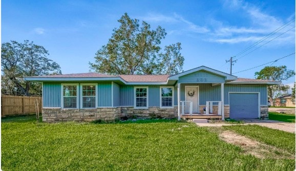 ranch-style house with a garage, stone siding, fence, and concrete driveway