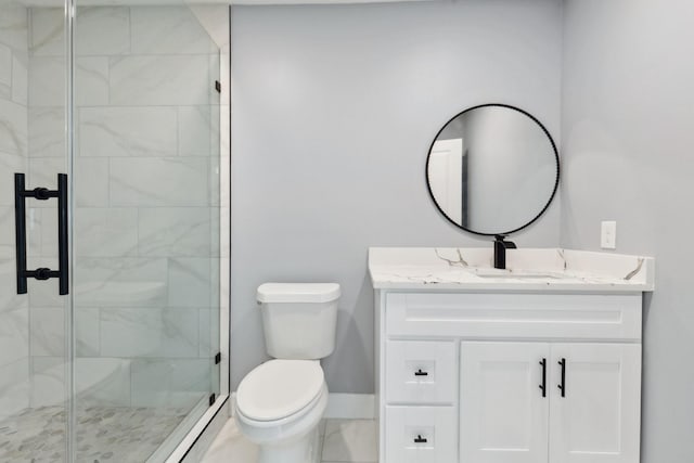 bathroom featuring baseboards, a shower stall, toilet, and vanity