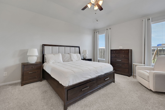 bedroom featuring light carpet, ceiling fan, and baseboards