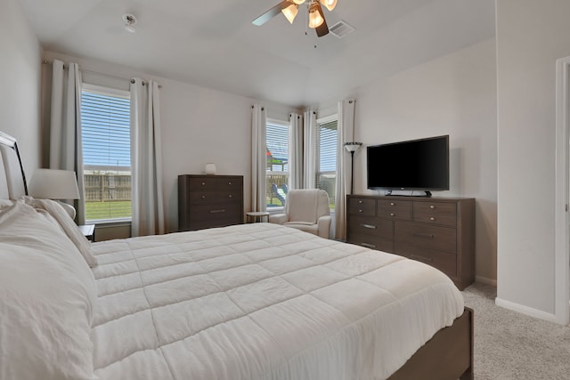 carpeted bedroom featuring multiple windows, baseboards, and ceiling fan