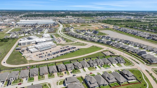 aerial view of property's location featuring a large body of water and nearby suburban area