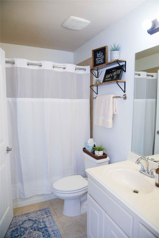 bathroom with toilet, a shower with curtain, tile patterned floors, and vanity