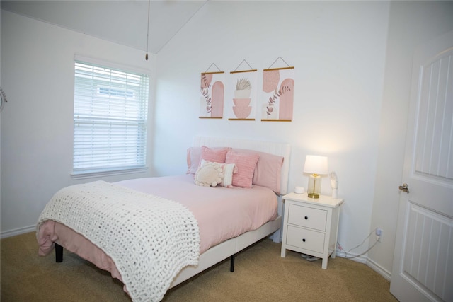 carpeted bedroom with baseboards, vaulted ceiling, and attic access