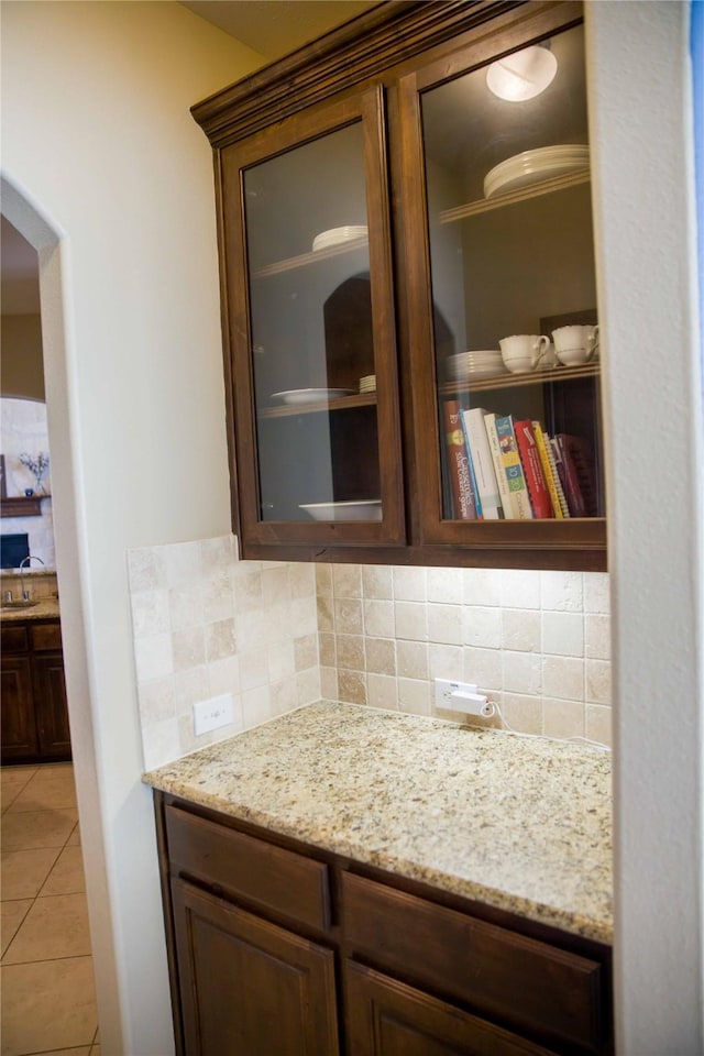 bathroom featuring vanity, tile patterned floors, and tasteful backsplash