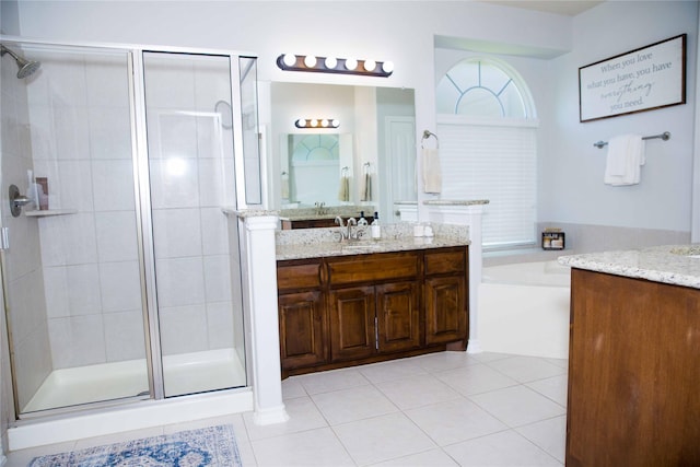 bathroom featuring a bath, a shower stall, tile patterned flooring, and vanity