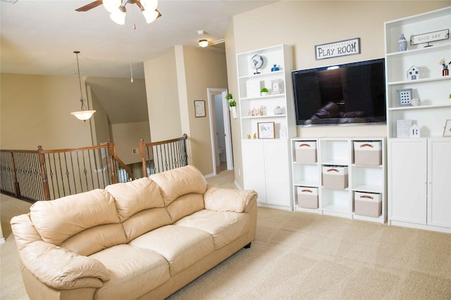 living area featuring carpet and ceiling fan