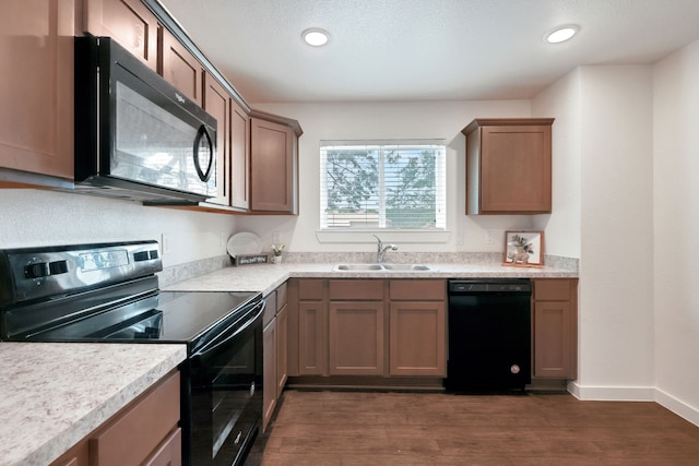 12603 Telge Rd Unit 30C-D, Cypress, TX 77429 - kitchen featuring black appliances, a sink, dark wood-type flooring, light countertops, and recessed lighting