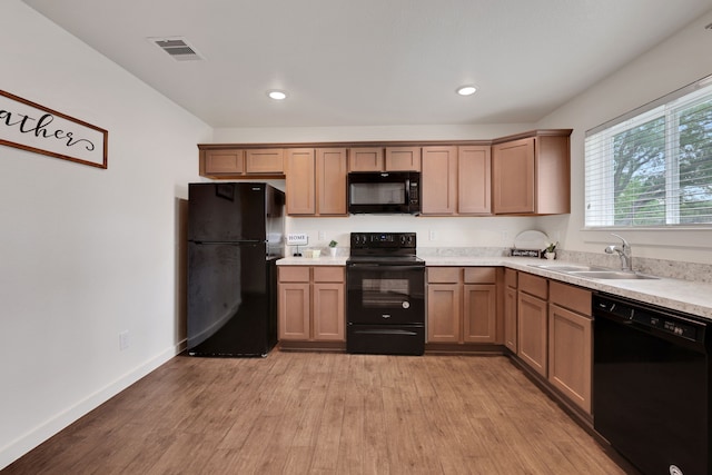 12603 Telge Rd Unit 30C-D, Cypress, TX 77429 - kitchen with black appliances, a sink, light wood-style floors, light countertops, and recessed lighting