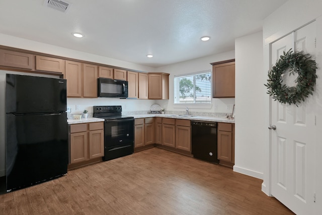 12603 Telge Rd Unit 30C-D, Cypress, TX 77429 - kitchen with black appliances, a sink, light wood-type flooring, and recessed lighting