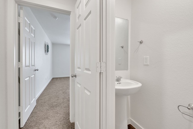 12603 Telge Rd Unit 30C-D, Cypress, TX 77429 - bathroom featuring baseboards and a sink