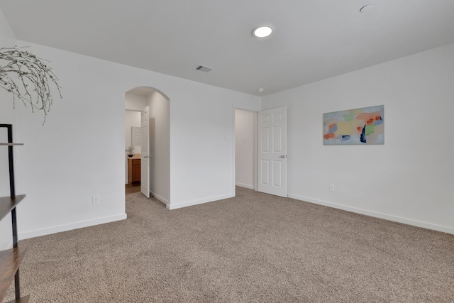 12603 Telge Rd Unit 30C-D, Cypress, TX 77429 - unfurnished bedroom featuring arched walkways, light colored carpet, and baseboards