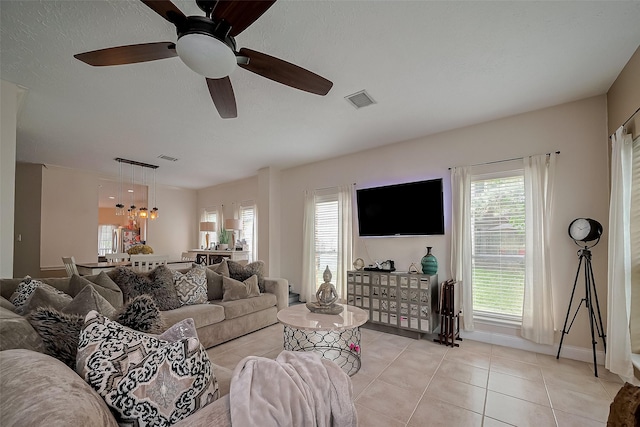 18914 Hikers Trail Dr, Humble, TX 77346 - living area featuring healthy amount of natural light, light tile patterned floors, a ceiling fan, and baseboards