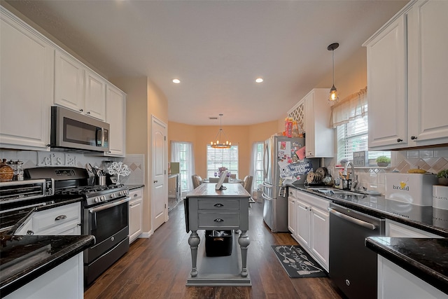 18914 Hikers Trail Dr, Humble, TX 77346 - kitchen featuring appliances with stainless steel finishes, a sink, white cabinetry, pendant lighting, and recessed lighting