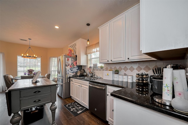 18914 Hikers Trail Dr, Humble, TX 77346 - kitchen featuring appliances with stainless steel finishes, white cabinets, a chandelier, dark wood finished floors, and recessed lighting