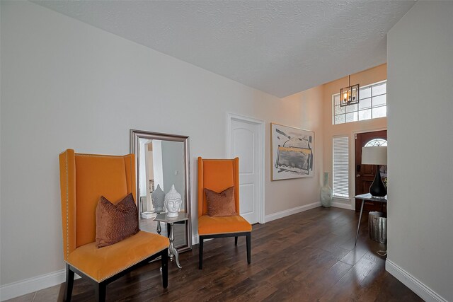 18914 Hikers Trail Dr, Humble, TX 77346 - sitting room featuring dark wood-type flooring, baseboards, a chandelier, and a textured ceiling