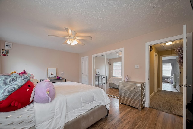 18914 Hikers Trail Dr, Humble, TX 77346 - bedroom featuring attic access, multiple windows, wood finished floors, and ceiling fan